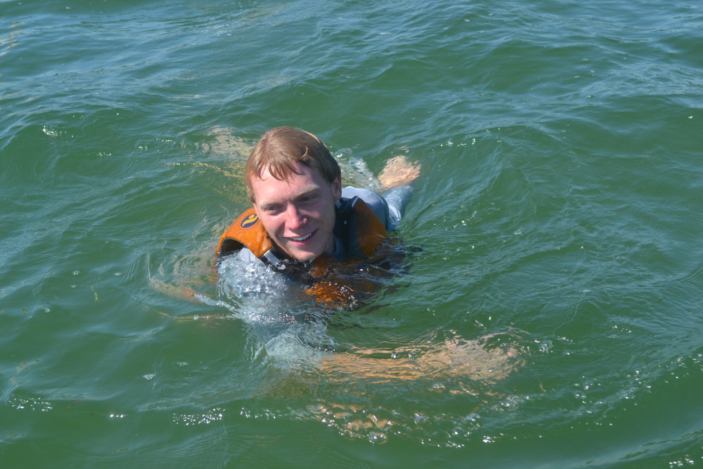 Michael Long swims in Sarasota Bay after helping a teen back onto a sailboat that capsized.