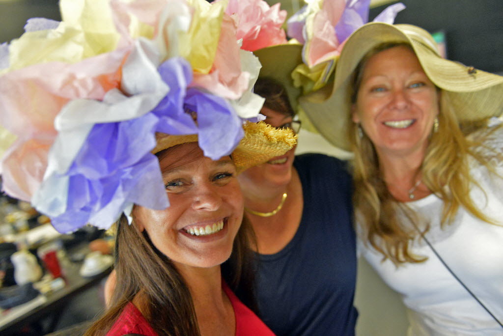 Kristi Wesszo, Duanna Paquette, and Amy Kobialka all of Sarasota have fun with their crazy hats during Sarasota's Kennel Club, 140th running of Kentucky Derby party. (May 3, 2014, Herald-Tribune Staff Photo by Thomas Bender)