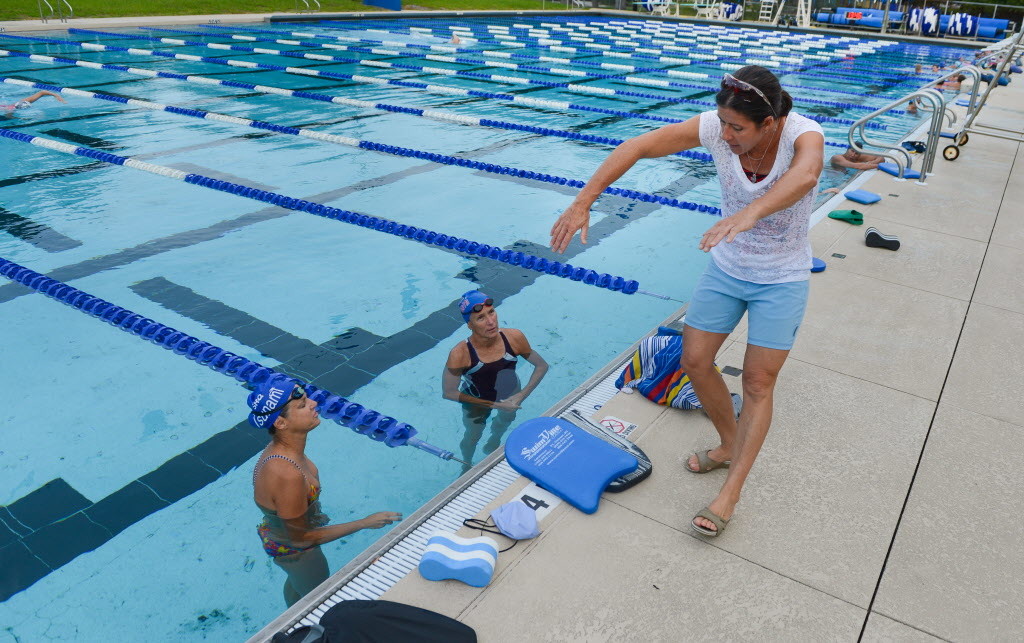 Four-time Olympian and gold medalist Sheila Taormina coaches swimmers in the Sarasota Tsunami Masters program at the Arlington Park Pool on Monday. STAFF PHOTO / DAN WAGNER