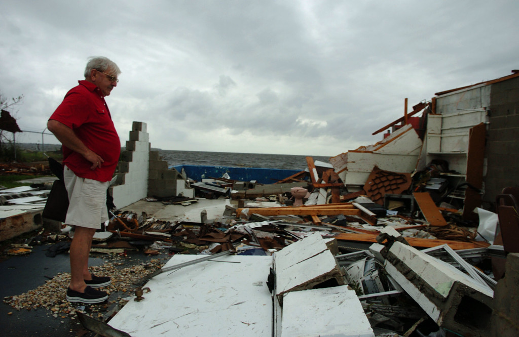 Thomas George surveys damage to his business Thomas J. George Realty, near Punta Gorda after Hurricane Charley moved through. Photo by Herald-Tribune archive.