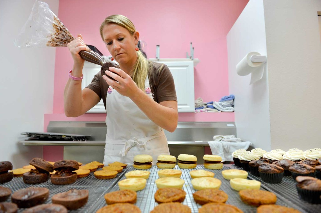 Becky Schultes, owner of Heavenly Cupcakes, decorates whoopie pies and cupcakes at her Gulf Gate store at 6538 Gateway Ave. in Sarasota, Fla.  Photo by Mike Lang