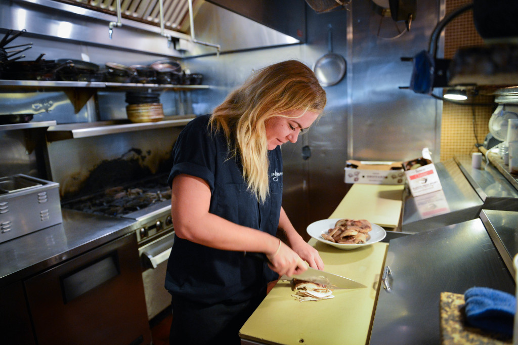 Chelsea Erickson, 27,  cuts up some mushrooms in the kitchen at Indigenous. Erickson is the sous chef at Indigenous.  Photo by Rachel S. O'Hara