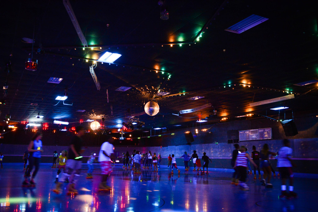 Skaters make their way around the ring during the "Glow Skate" portion of the night at Stardust Skate Center.  Photo by Rachel S. O'Hara