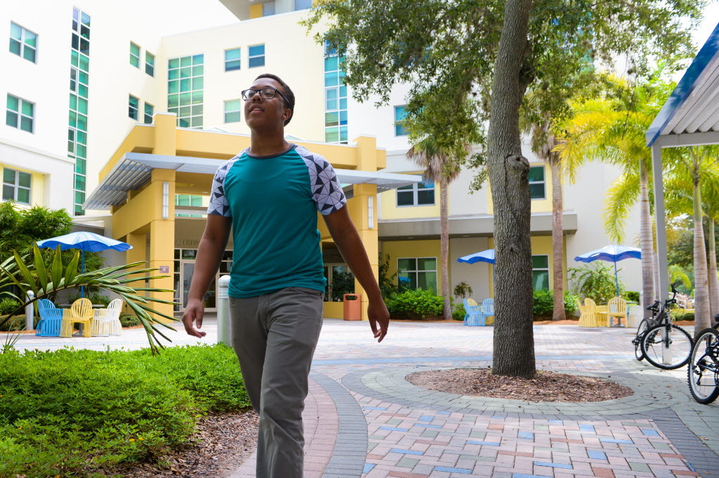 Jamiel Law, a first-year illustration major, walks though central campus at Ringling College of Art + Design. Photo Credit: Dan Wagner