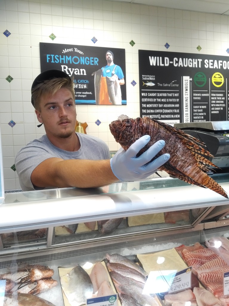 A Whole Foods employee at 1451 First Street holds a lionfish. Whole Foods is selling the invasive species on sale for $8.99 a pound through Tuesday. The sale will help introduce the fish to customers who haven’t tried it before. Photo by Caitlin Ostroff
