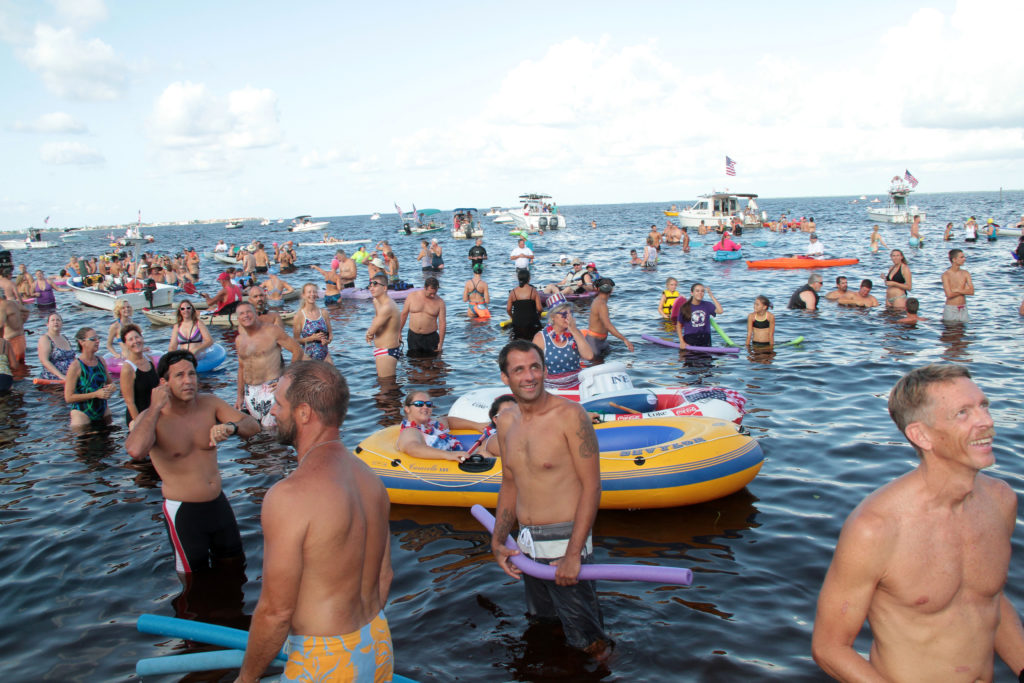 Estimated over 700 participated in the 2014 Annual Freedom Swim in Charlotte County, starting off at 9am from the Port Charlotte side of the Charlotte Harbor, ending at Harpoon Harry's in Fishermen's Village, Punta Gorda. Swimmers gather at the shoreline for a brief message and instructions from Mike Haymans one of the originators of the swim over twenty years ago.