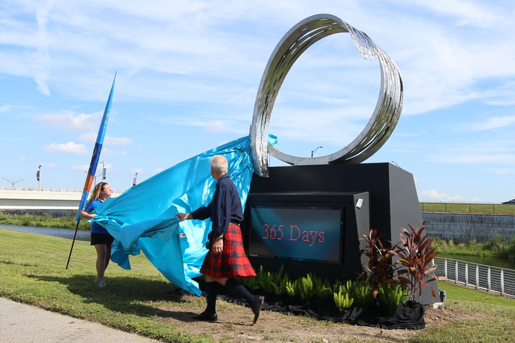 Sculptor Malcolm Robertson and SANCA Event Director Meredith Scerba unveil the sculpture designed for the 2017 World Rowing Championships being held at Nathan Benderson Park one year from now. Herald-Tribune photo / Janet Combs