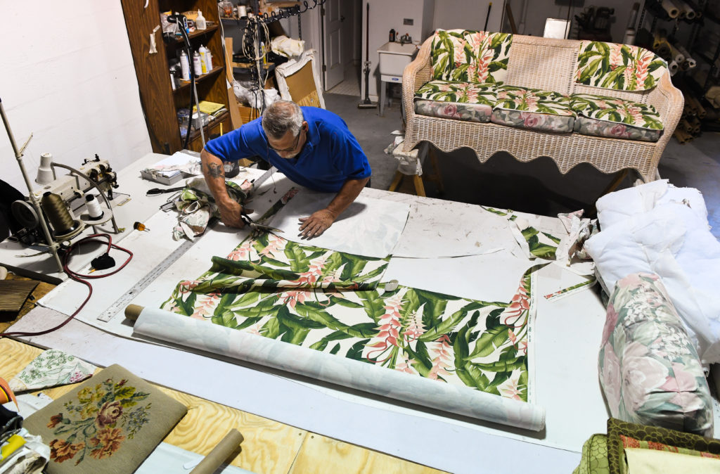 Terry Heilmann reupolsters a sofa at Mission Avenue Studios. Herald-Tribune staff photo / Dan Wagner