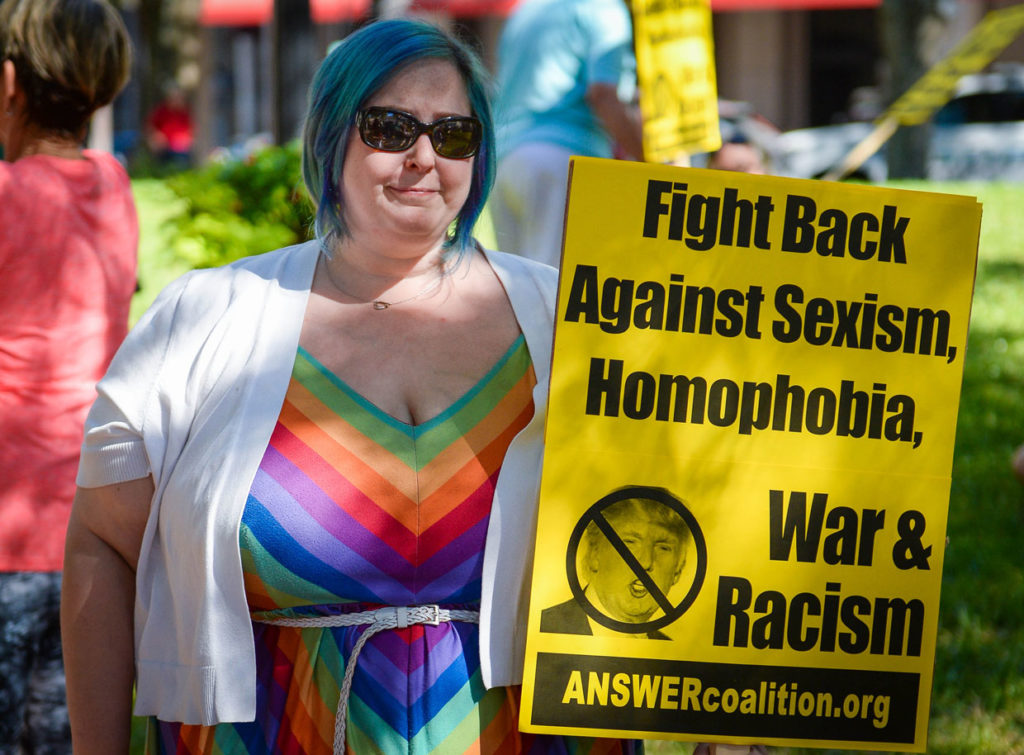 Alisa Lannon holds up one of the ANSWER coalition signs at the protest Saturday, November 12 at Five Points Park in downtown Sarasota. 
