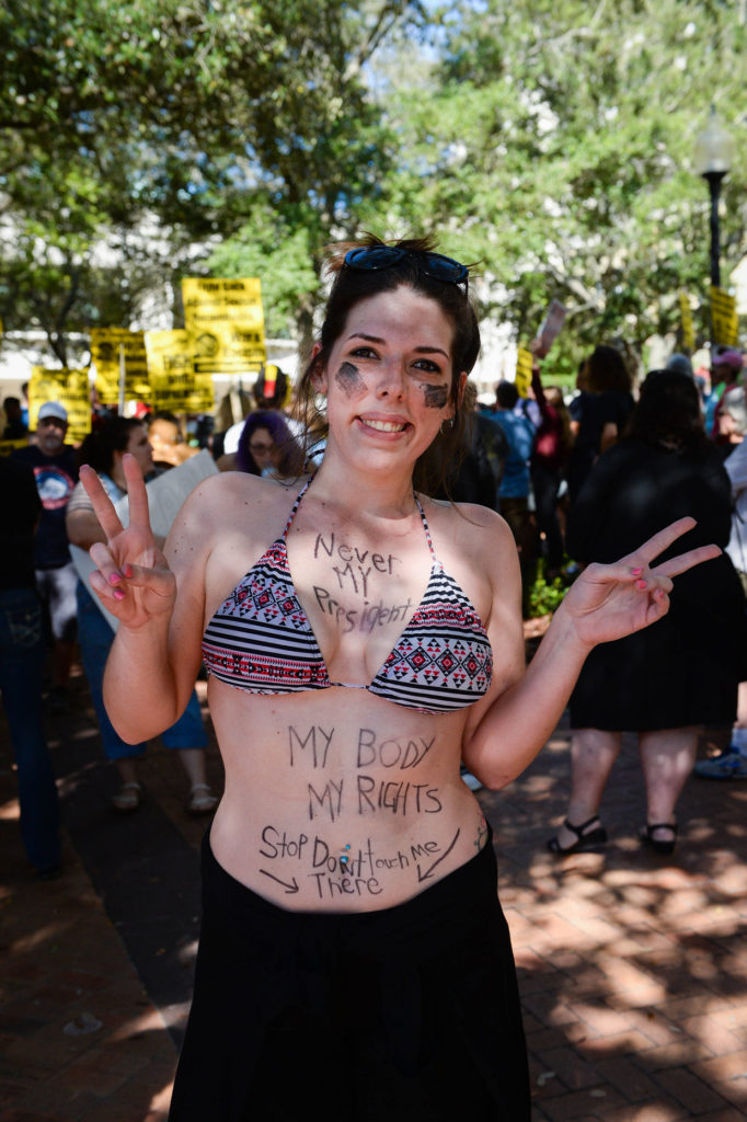Taylor Daly decorated her body rather than making a sign for the protest.