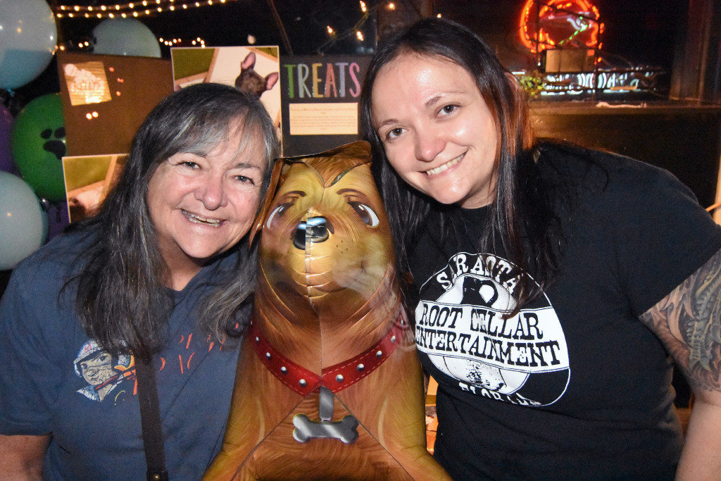 Cindy O'Shea and her daughter Kate O'Shea pose with TREATS Dog Rescue display. Kate O'Shea is the founder of Root Cellar Entertainment and the organizer of Saturday night's Johnny Cash tribute.